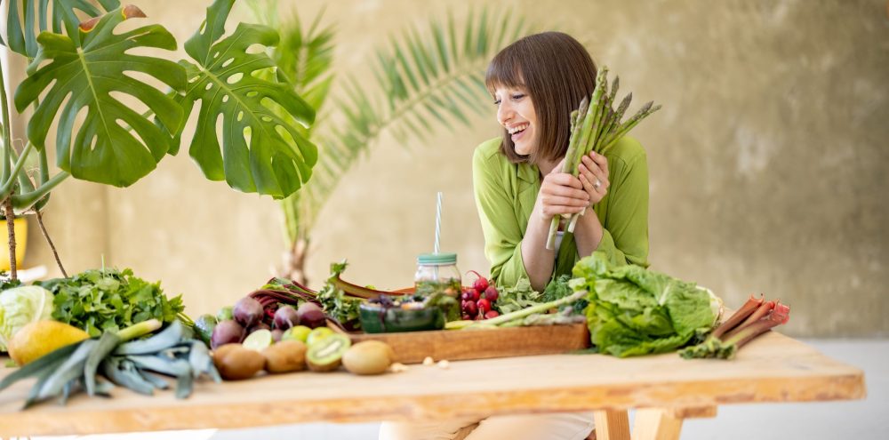 Woman with fresh healthy food ingredients indoors